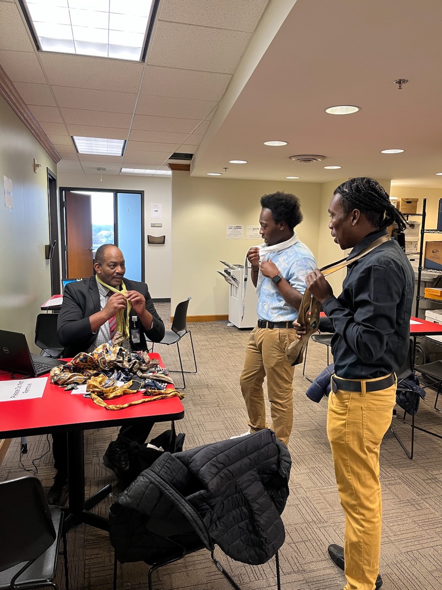 Mentor helping youth with professional attire