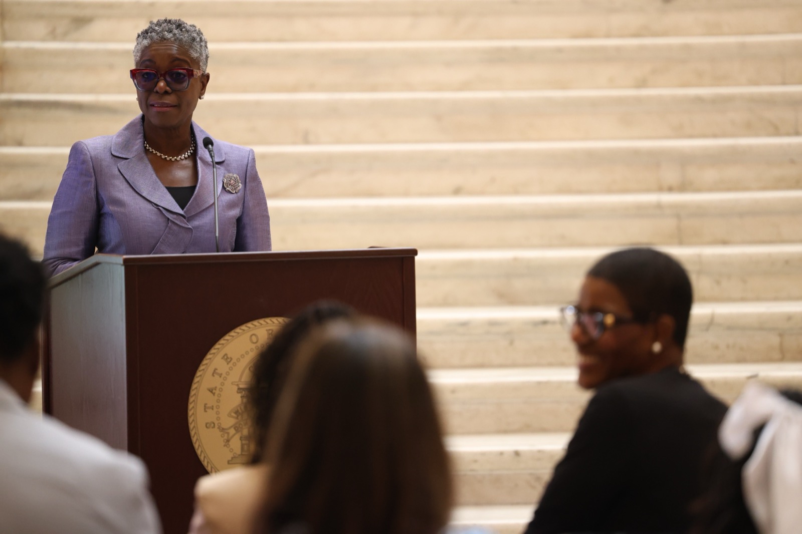 Omotayo Alli, Executive Director of the Georgia Public Defender Council, welcoming distinguished guests, graduates, and their families to the ceremony.