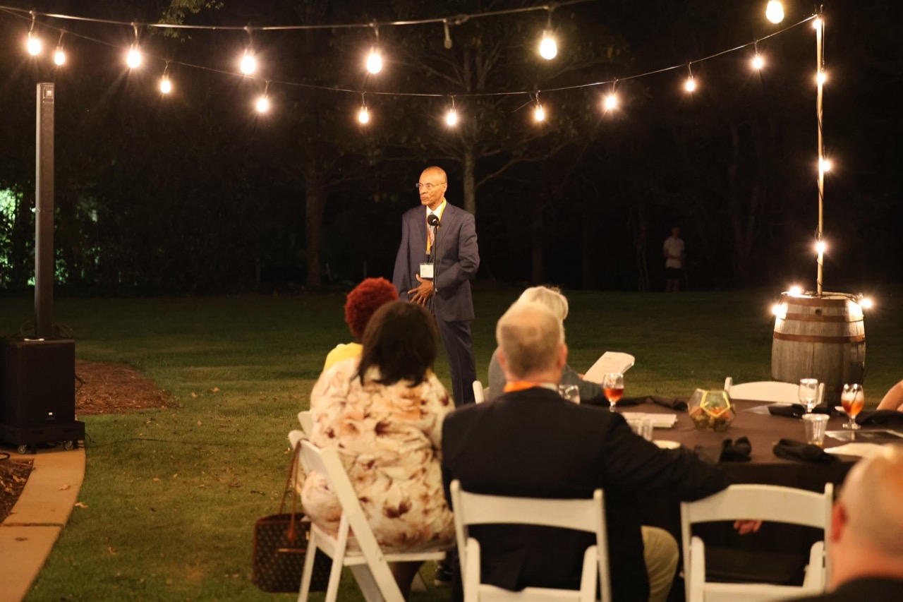 D’Andre Berry, Director of Information Systems and Performance Metrics, speaks to the class after dark.